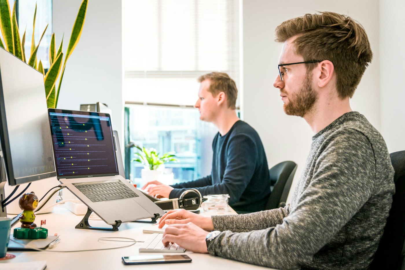 Engineers reviewing code together at a workstation