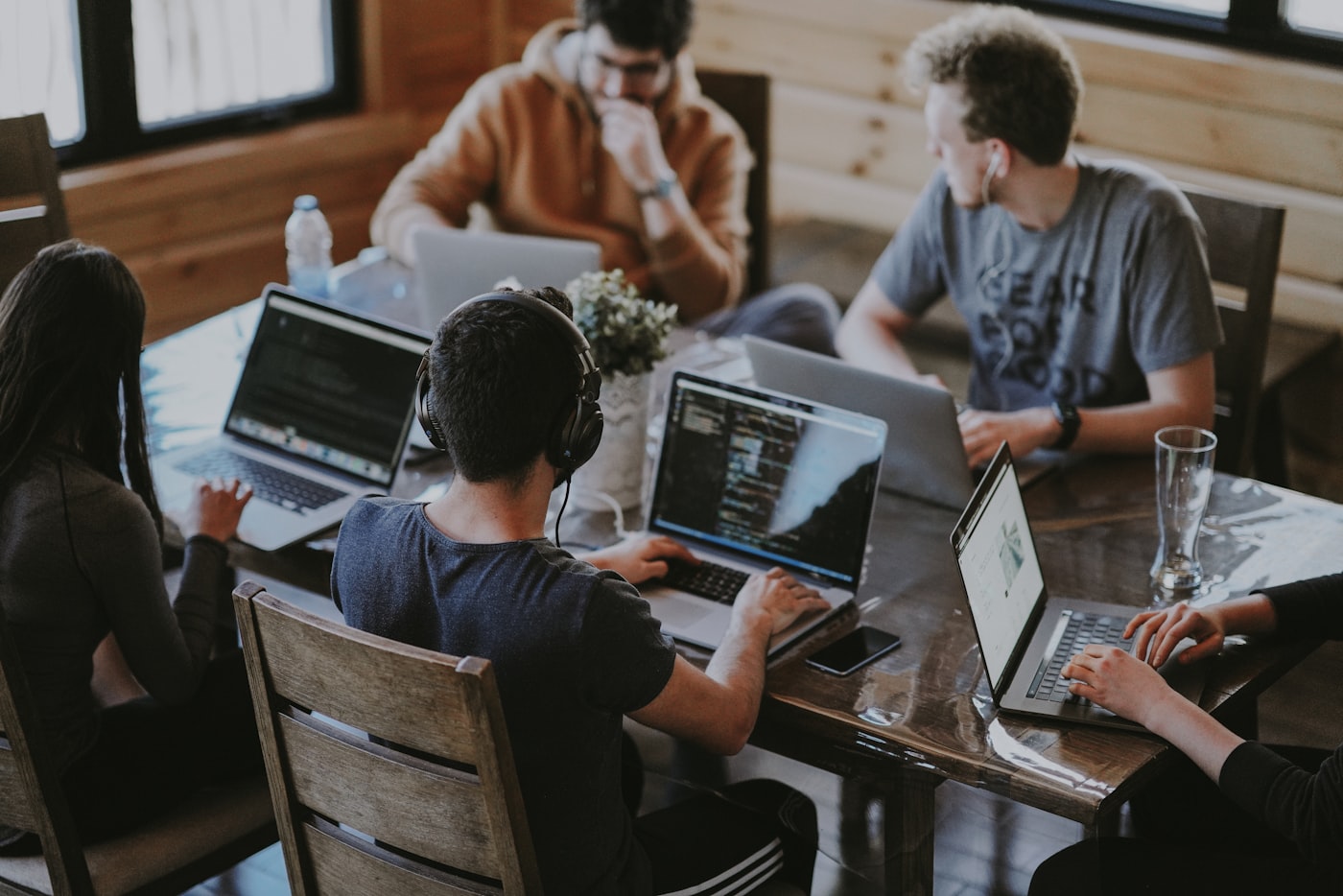 A small product team collaborating around a table during a working session